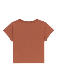 Camiseta de manga corta en color óxido, hecha de algodón. Presenta un escote redondo y un corte holgado. Color uniforme sin patrones ni detalles visibles.