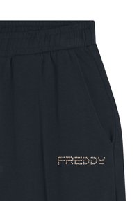 Pantaloni della tuta navy scuro con cintura elasticizzata, dotati di tasche laterali e logo "FREDDY" con borchie dorate sul lato sinistro in basso.