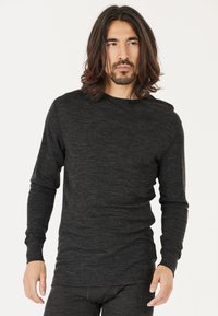 Schwarzes langärmliges Thermoshirt aus weichem, strukturiertem Stoff. Mit Rundhalsausschnitt und tailliertem Schnitt, mit glatter Oberfläche.