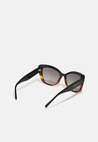Cat-eye sunglasses with black and tortoiseshell frames, gradient gray lenses, and gold hardware accents on the arms.