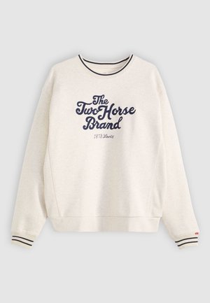 Lys beige hettegenser med marineblå logo tekst, stripete ribbestrikkede mansjetter og design med rund hals. Laget av myk stoff, med en avslappet passform.