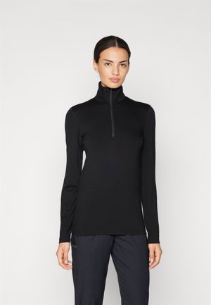 Svart langermet topp med høy krage og glidelås. Laget av et glatt, stretchy stoff. Minimalistisk design uten synlige mønstre eller logoer.