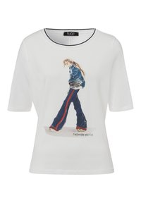 White short-sleeve T-shirt with a printed graphic of a figure in blue jeans and a denim jacket, featuring the text “FASHION VICTIM” below.