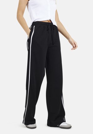 Pantaloni della tuta neri con strisce laterali bianche, vita elastica con cordino, vestibilità casual, realizzati in tessuto morbido, dotati di tasche frontali.