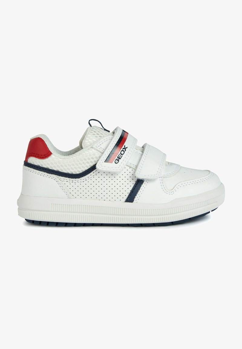 Sneaker bianco con design perforato, linguetta in mesh imbottita e doppie fasce in Velcro. Presenta dettagli rossi e blu navy, suola in gomma per una buona aderenza.