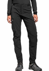 Schwarze Outdoor-Hosen mit passgenauer Passform, ausgestattet mit Reißverschlusstaschen, verstärkten Nähten und verstellbaren Taillen für Komfort und Funktionalität.