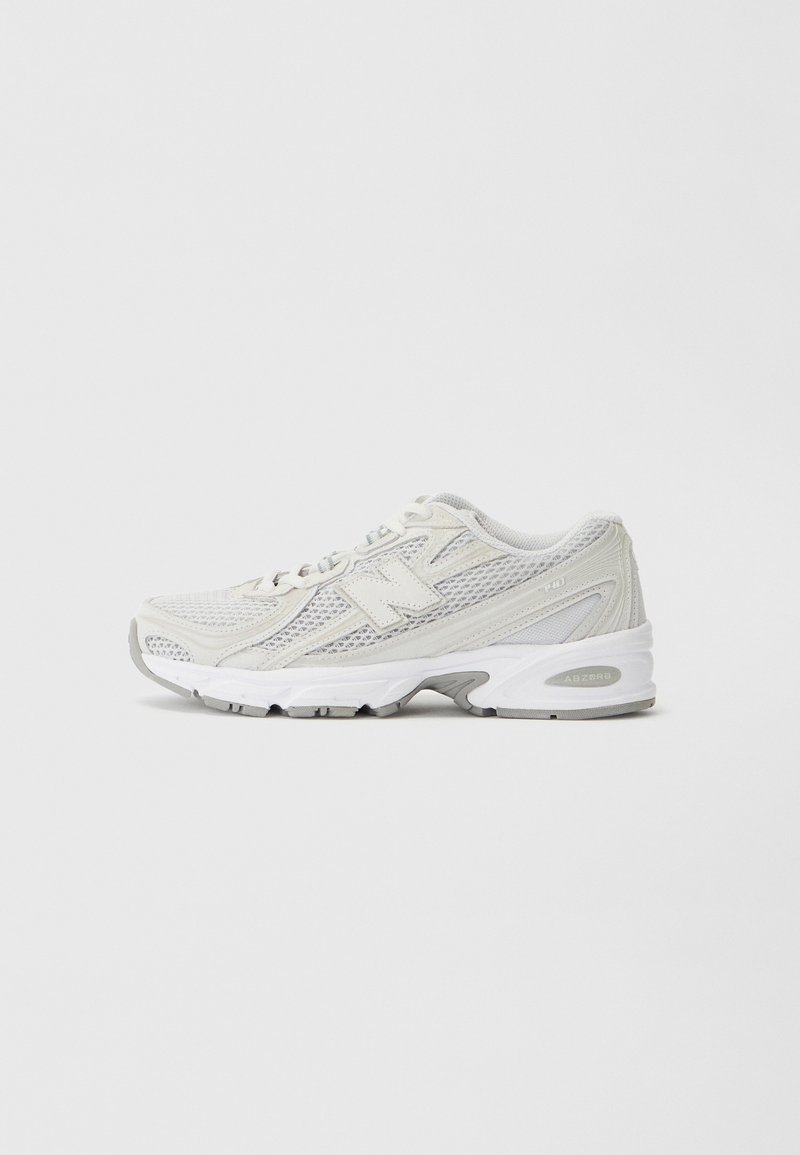 Lightweight running shoe in off-white mesh, featuring a padded collar, laces, and grey accents; cushioned sole with grip pattern.