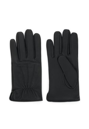 Paire de gants en cuir noir posée à plat avec des coutures visibles et un léger détail élastique au niveau du poignet.