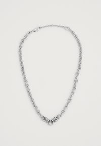Silver chain necklace with large links, featuring a central decorative clasp with intricate detailing. Smooth, shiny surface throughout.