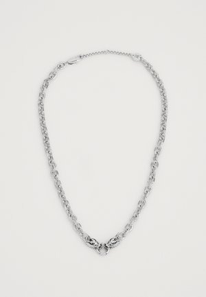 Collar de cadena de plata con eslabones grandes, que presenta un cierre decorativo central con un intrincado diseño. Superficie lisa y brillante en todo momento.