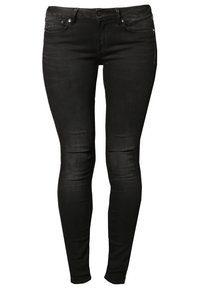 Jean skinny noir avec poches avant et arrière, fermeture par boutons et texture légèrement délavée sur les genoux et les cuisses.