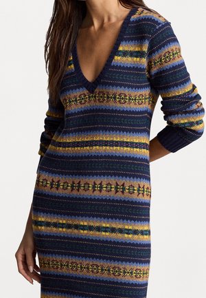 Knit sweater dress with a deep V-neck, featuring multicolor horizontal stripes in navy, green, gold, and brown, with varying patterns.