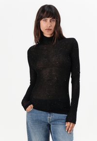 Svart langermet turtleneck genser med gjennomsiktig stoff, pyntet med spredte små glitrende detaljer. Tettsittende design med en glatt tekstur.