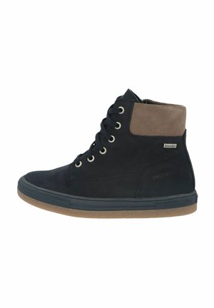 High-top sneakers made of black suede with a tan suede ankle collar, featuring metal eyelets and a rubber sole.