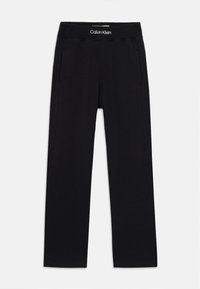 Pantalones de chándal negros de Calvin Klein con cintura elástica, dos bolsillos laterales y un acabado de tela de algodón suave. Diseño casual de pierna recta.