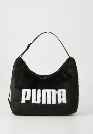 Melnas mākslīgās kažokādas somiņa ar noapaļotu formu, kurai ir izteikta balta "PUMA" logotips. Tam ir regulējams melns siksniņš. Gluda tekstūra.