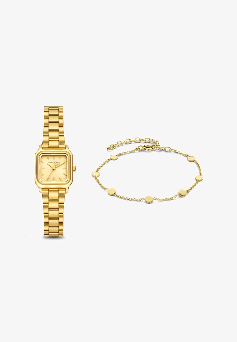 Goldfarbene Uhr mit quadratischem Ziffernblatt und Gliederarmband, daneben ein zartes goldfarbenes Armband mit runden Gliedern.