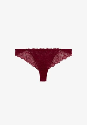 String en dentelle bordeaux affichant des motifs floraux, des bords festonnés et une taille lisse ; texture délicate et semi-transparente.