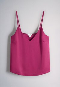 Magenta sleeveless top with thin adjustable straps and a V-neckline hanging against a light gray background.