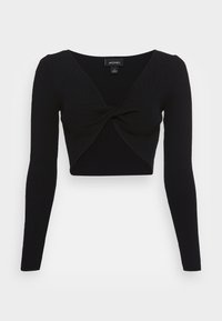 Top cropped preto com mangas longas, decote V profundo e design frontal torcido. Feito de tecido com textura canelada.