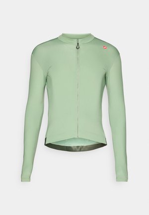 Maglia da ciclismo verde chiaro a maniche lunghe con zip frontale completa e piccolo logo rosso sul lato sinistro del petto.