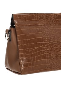 Braune Tasche aus Kunstleder mit Krokodilprägung, klappbarem Design und silberfarbenen Metallakzenten. Glatte Oberfläche und strukturierte Form.