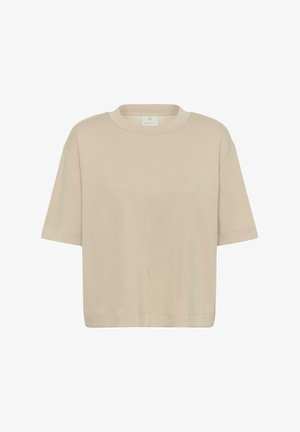 Beżowa koszulka z krótkim rękawem, okrągłym dekoltem, o luźnym kroju i minimalistycznym wzornictwie.