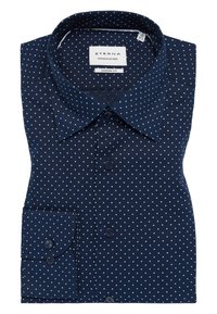 Camicia da uomo blu navy con motivo a pois bianchi, colletto button-down e polsino singolo con due bottoni. Realizzata in tessuto liscio.