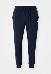Námornícke modré jogger nohavice s elastickým pásom, šnúrkou, bočnými vreckami, s manžetami na členkoch a bielym logom na ľavom stehne.