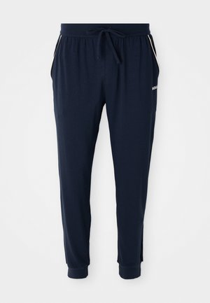 Námornícke modré jogger nohavice s elastickým pásom, šnúrkou, bočnými vreckami, s manžetami na členkoch a bielym logom na ľavom stehne.
