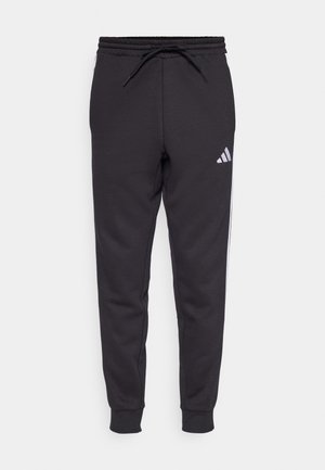 adidas Sportswear ESSENTIAL THREE STRIPES  - Tracksuit bottoms - black/white