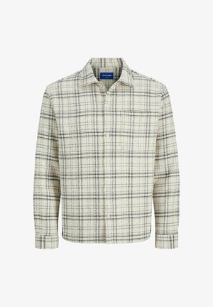 Plaid shirt in cream and dark blue, featuring a button-down front, long sleeves, and a classic collar. Textured fabric with grid pattern.