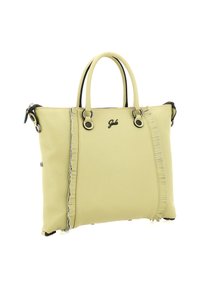 Borsa a mano in pelle gialla con superficie strutturata, manici arrotondati e dettaglio decorativo a frange su un lato. Dotata di dettagli in metallo.