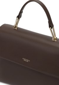 Brown leather handbag with a structured design, gold-tone hardware, and a top handle. Features subtle stitching and embossed brand logo.