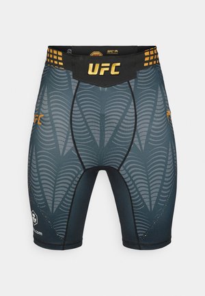 UFC kaubamärgiga vormiriietuse lühikesed püksid tumesinises toonis, tekstureeritud lainemustriga, musta värvi vöökohaga, millel on kuldsed detailid ja tugevust tagavad lamedad õmblused.