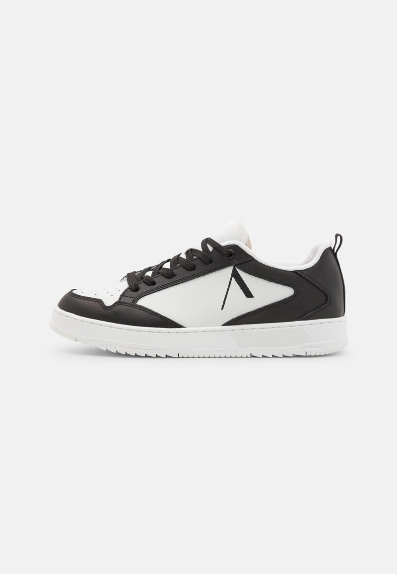 Baskets basses en cuir noir et blanc, lacets noirs, semelle blanche et logo noir minimaliste sur le côté.