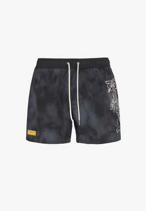 Pantaloni da bagno neri con motivo tie-dye, vita elastica, chiusura con cordino e ricamo floreale bianco sul lato.