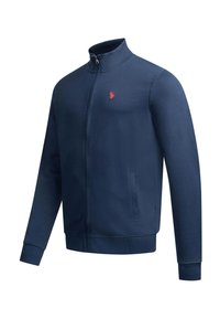 Marineblaue Zip-up-Jacke mit hohem Kragen, langen Ärmeln, Seitentaschen und kleinem roten gesticktem Logo auf der linken Brust.