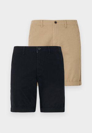 Two pairs of shorts: one navy blue and one khaki. Both are made of cotton, feature a flat front, roll-up hem, and a button closure.