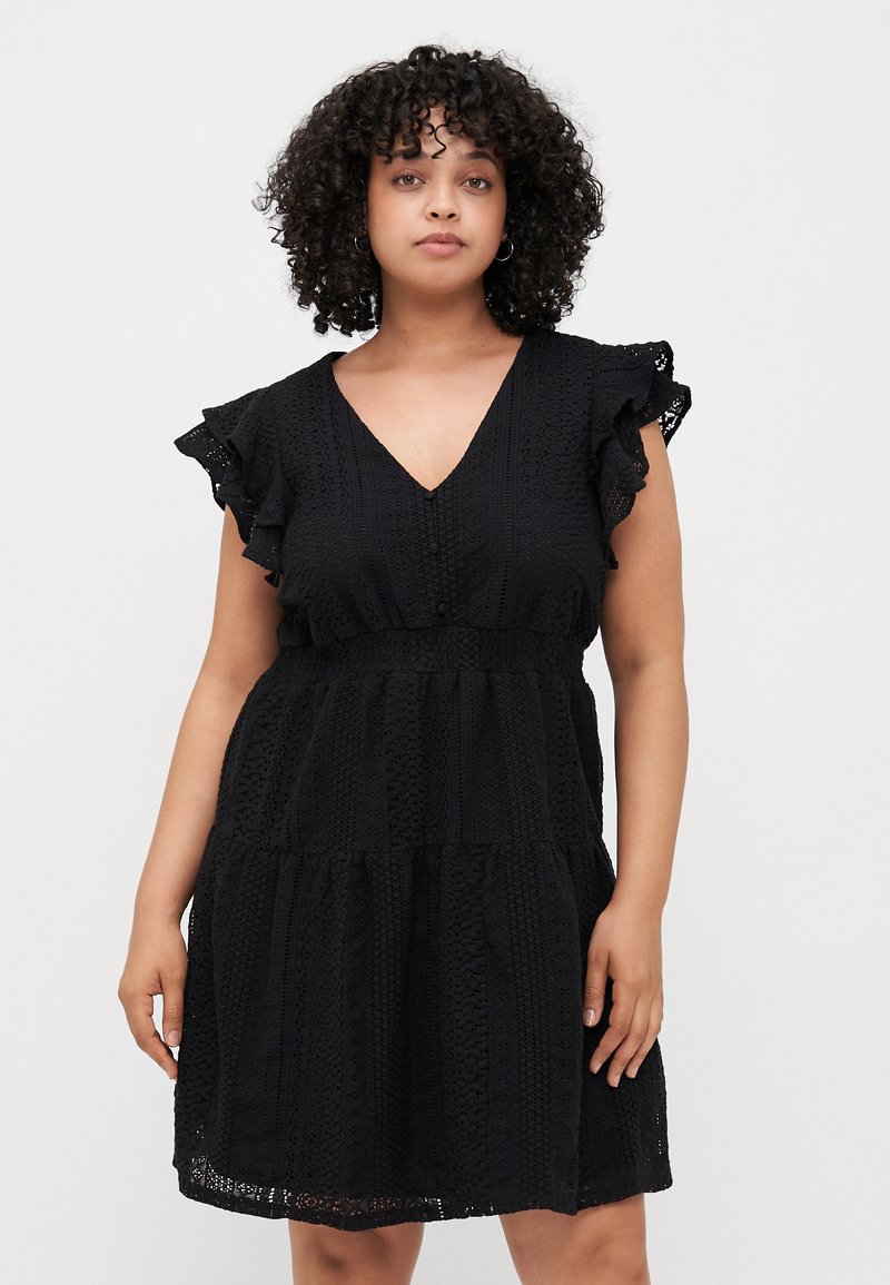 Black, short-sleeve dress with a V-neck, tiered design, and textured fabric featuring lace-like patterns. Ruffled sleeves add detail.