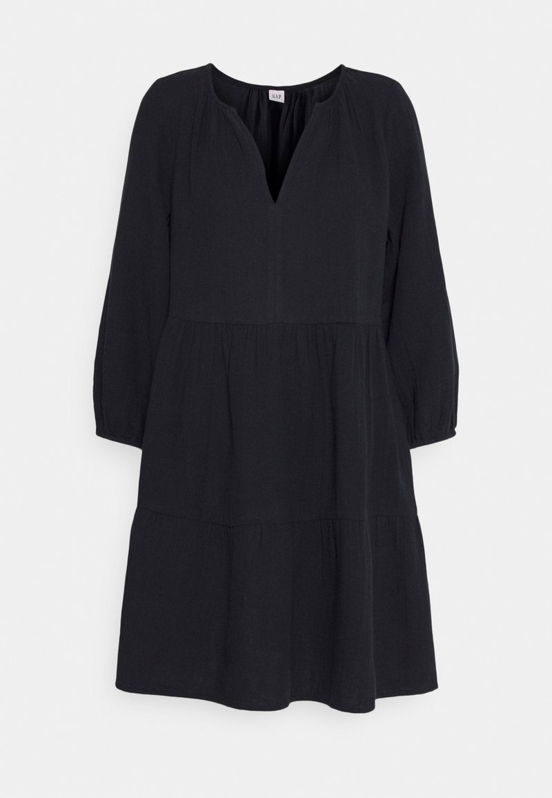 Robes noires à manches longues, longueur genou, avec une jupe à volants et un décolleté en V, ornée de fronces aux épaules et à la taille.