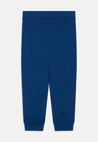 Dunkelblaue Sweatpants aus weichem Stoff, mit einem elastischen Bund und gerippten Bündchen an den Knöcheln. Einfaches und glattes Design.
