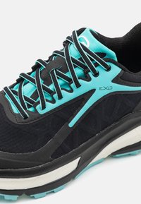 Black running shoe with textured fabric upper, turquoise accents, and patterned laces. Features a cushioned sole with a white midsection.