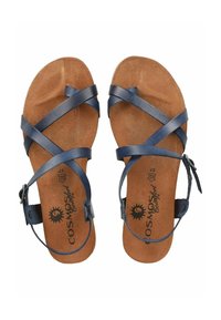 Navy leather sandals with cross-strap design, featuring a textured cork footbed and a buckle fastening on the ankle strap.