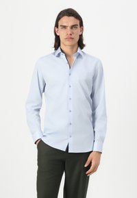 Light blue, long-sleeve dress shirt with a button-up front, collared neck, and smooth texture. Buttons are dark blue, contrasting with the fabric.