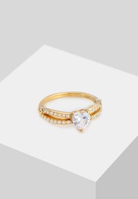Goldring mit herzförmigem Mittelstück und klaren Zirkonia-Akzenten. Verfügt über ein geteiltes Banddesign mit kleinen Steinen entlang des Schaftes.