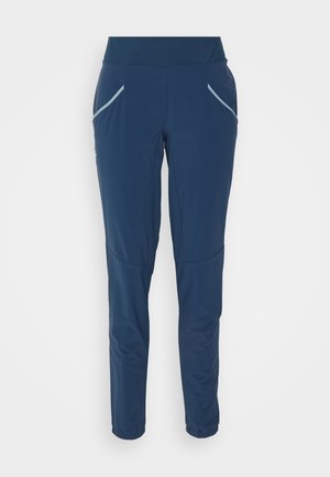 Pantalons de sport bleu marine en tissu lisse, dotés d'une taille haute, de deux poches avant et de poignets élastiques aux chevilles.