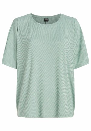 Haut vert menthe à manches courtes avec un motif en chevron, doté d'un col rond et d'une coupe décontractée. Fabriqué en tissu léger et texturé.