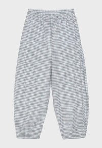 Pantalon de pyjama ample à carreaux avec taille élastique et jambes fuselées dans un motif blanc, noir et bleu clair.