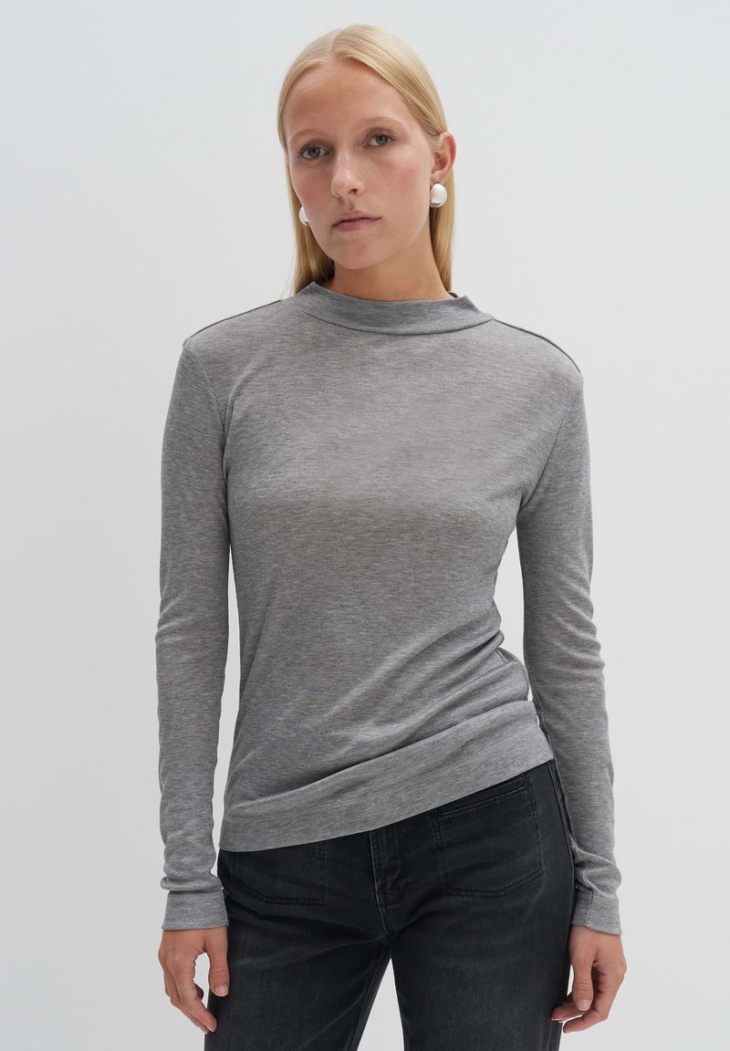 Grey long-sleeve t-shirt with a high neck, made of soft fabric, featuring a relaxed fit and subtle stitching detail on shoulders.